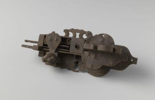 Iron lock, clover-shaped and with engraved vine motifs.