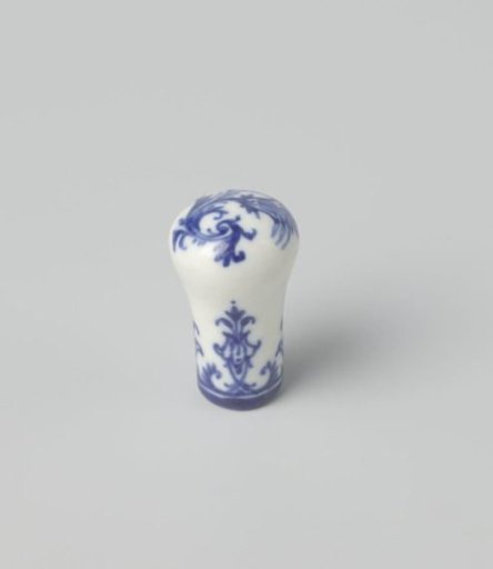 Cane knob with a stylized flower and floral scrolls