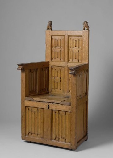 Armchair with chest-shaped base, decorated with letter panels. Heads of the rear stiles in the form of shield-bearing lions.