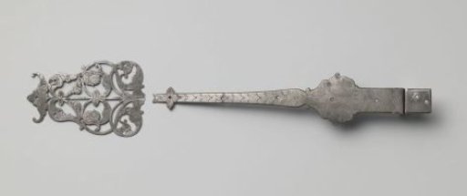 Door hinge of tinned iron, decorated with engravings and fool's heads