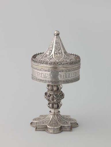 Ciborium, cylindrical, on high round foot and with conical lid, chased with floral ornaments