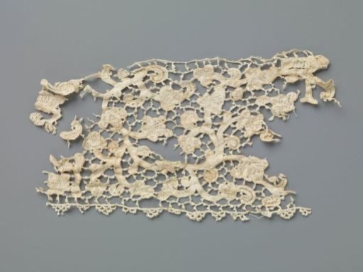 Strip of needle lace with curling vines and various flowers