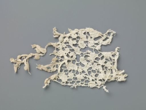 Strip of needle lace with curling vines and various flowers
