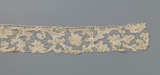 Strip of needle lace with interrupted volute scrolls and flowers