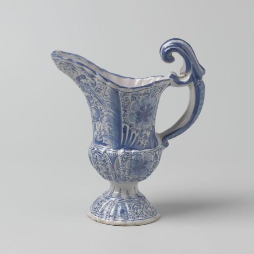 Jug on a round, constricted foot, with a long spout and painted in blue