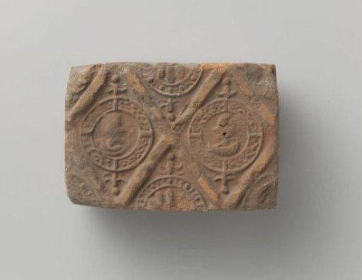 Fireplace with a man's and a woman's head and profile in two profiled lozenges