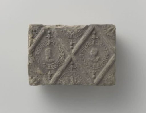 Fireplace with a representation of a man's and a woman's head in two profiled diamonds