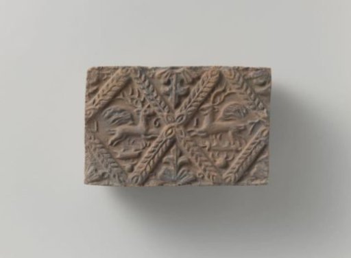 Fireplace of baked clay with a diamond-shaped division, with two winged stags in two diamonds