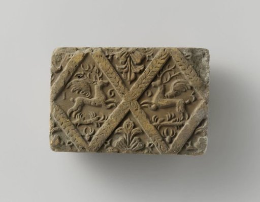 Fireplace tile of baked clay with a diamond-shaped division, featuring two winged stags in two panels