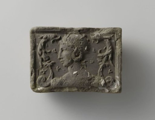 Fireplace with a crowned female head in the center