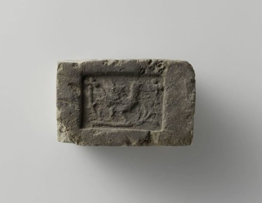 Fireplace surround with a bird on a branch and two clover leaves in the corners