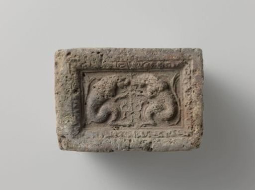 Fireplace with Two Lions Sitting Opposite Each Other, with a Plant Stem Between Them