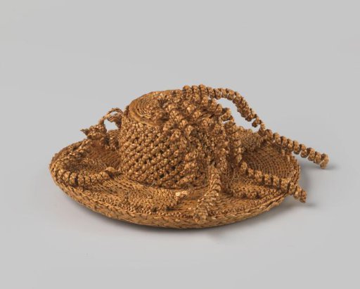 Doll's hat of woven straw with high cylindrical dome and spiral ornaments