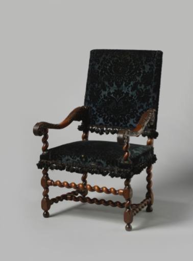 Armchair with splayed legs, upholstered in black embossed velvet with a pattern of symmetrical distorted pomegranate motifs and acanthus leaves