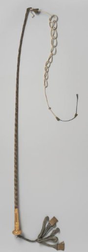 Whip, covered with purple velvet with gold-colored flowers on the golden knob on which a boy with a wreath hangs a tassel of purple silk with gold thread