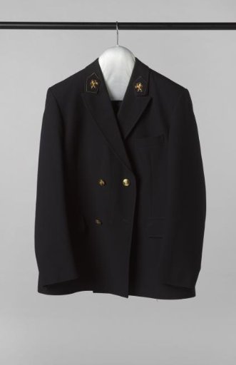 Short Jacket of Black Wool and Polyester, with Two Sets of Two Gold Buttons Featuring a Crowned Coat of Arms and a Standing Lion, and Two Insignia on the Lapels, with a Gold Lion on a Blue Field