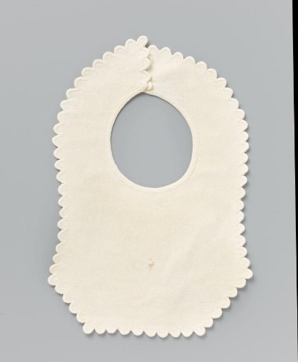 Slab of white cotton (?) with woven wave motif in relief and scalloped festooned border
