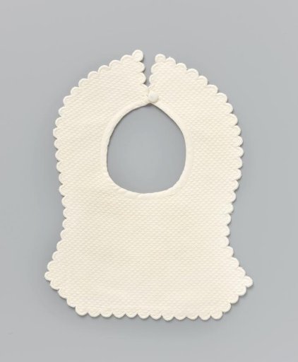 Piece of white linen (?) with piqué and a carved festooned border; the corners extend downwards at the bottom