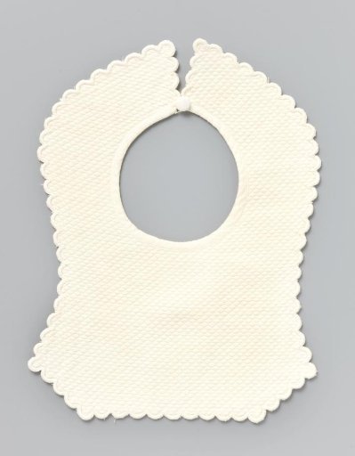 Piece of white linen (?) with piqué and a carved festooned border; the corners extend downwards at the bottom