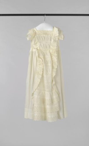 Children's dress of white cotton with inserts, ruffles, and short sleeves of English embroidery