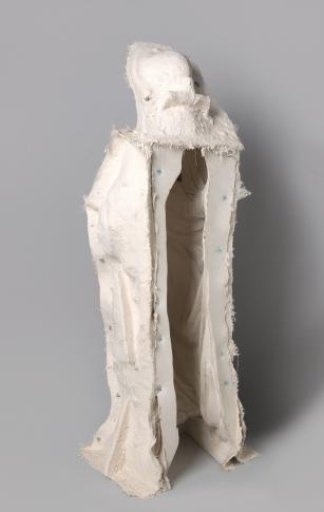 Full-length female figure holding a mirror. From the façade of the Rijksmuseum villa