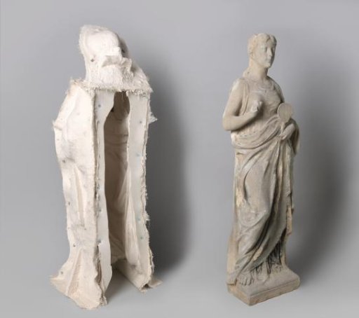 Full-length female figure holding a mirror. From the facade of the Rijksmuseum villa