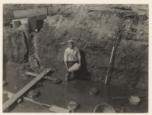 Man holding a pickaxe during construction work