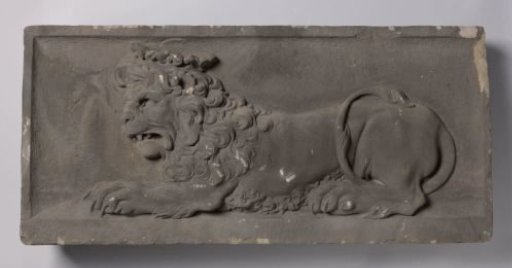 Gable stone with a recumbent crowned lion facing left.