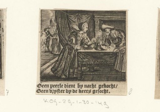 Couple examining pearls by candlelight