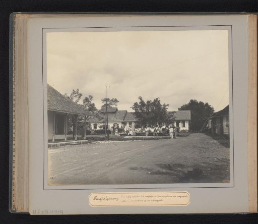 Pangkalpinang. A view between the warehouse and office building with wagon fleet, workshop and locomotives in the background