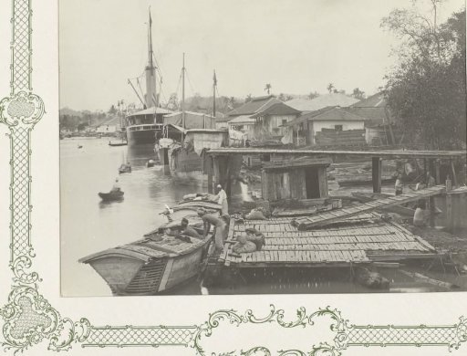 Ship and boats in a harbor in Borneo