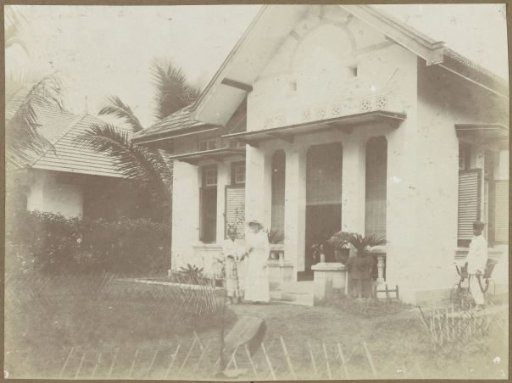 Woman and son in front of the house on Wilhelmina Street