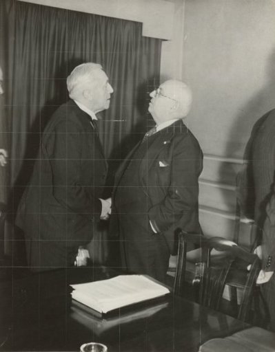 Minister Bolkestein greeting his colleague Minister O.C.A. van Lidt de Jeude at Stratton House in London