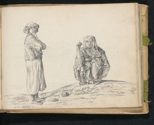 Two women; one standing, one squatting