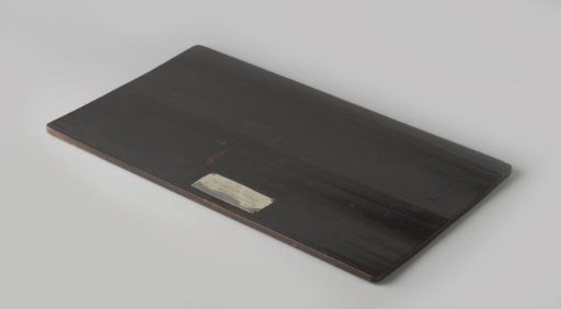 A wooden tray belonging to the silver model of an Indonesian house