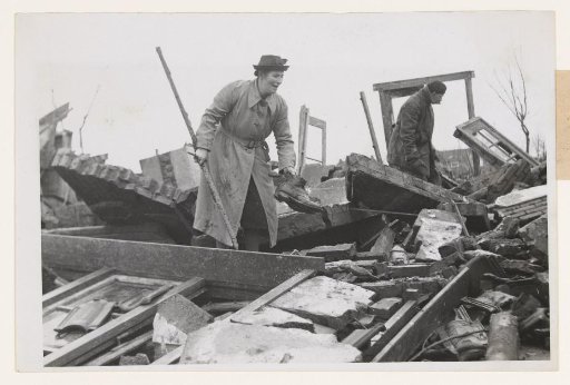 Former resident searches for usable belongings in her old, completely destroyed house