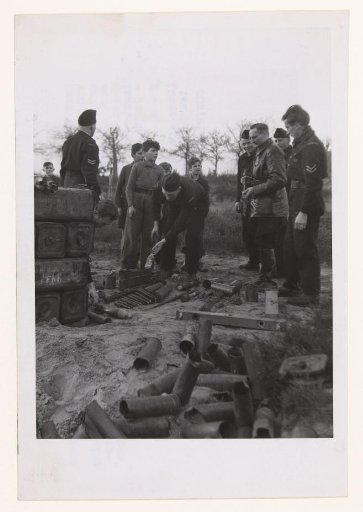 The Royal Police address children while picking up weapons from the battlefields in the South of the Netherlands