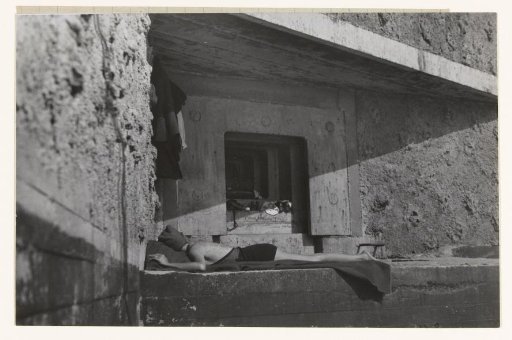 Sunbather lying in the shelter of a fortification