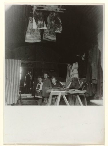 Three Children in a Makeshift Dwelling