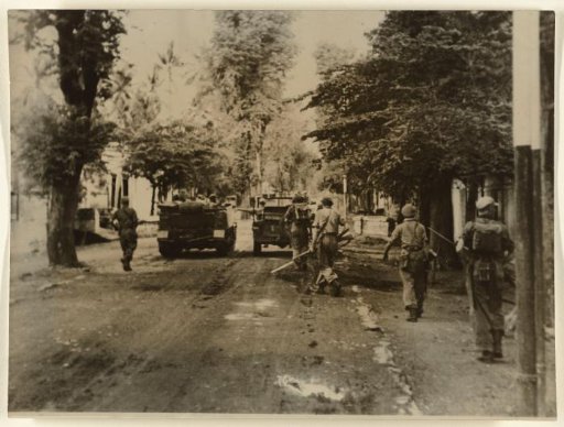 Dutch Troops Advance Under Cover of Bren Gun Carriers in Solo