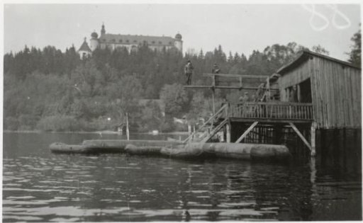 Wehrmacht soldiers in a wooden building by a river