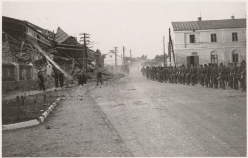 Soldiers walking through a ruined city