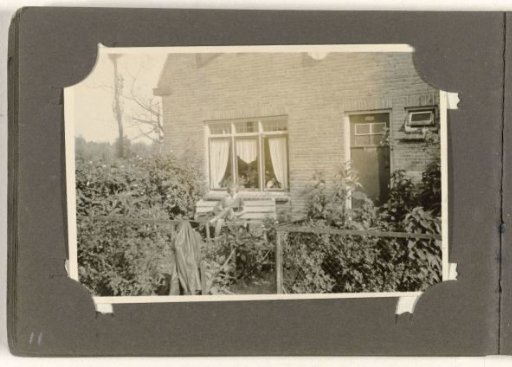 Young woman reading in front of a house