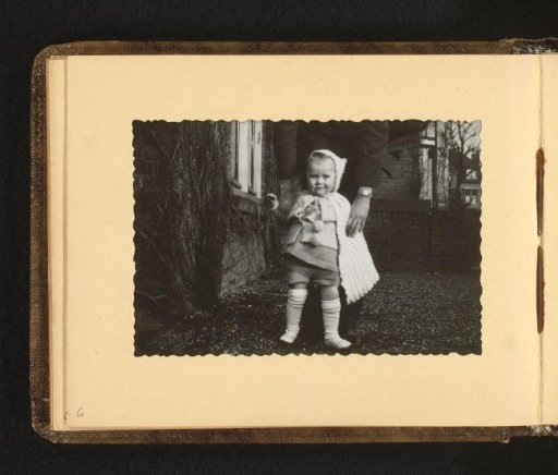 Toddler standing before a man