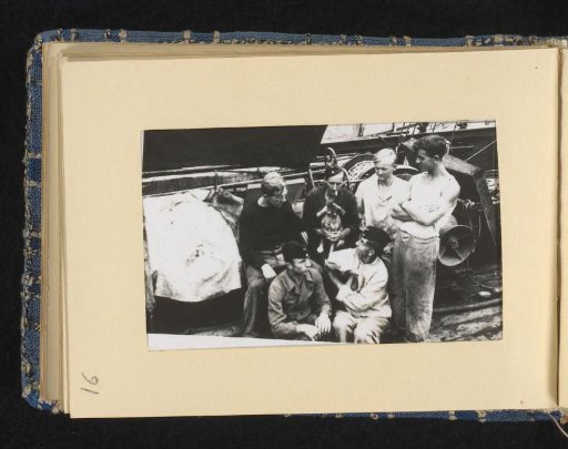 Sailors on board their ship with a dog