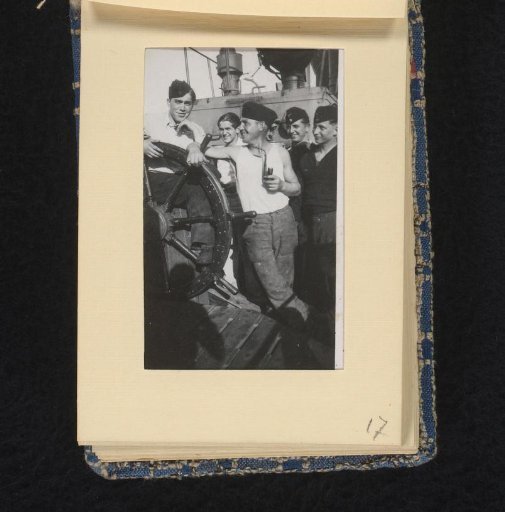 Sailors on board their ship at the helm