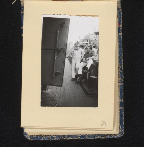 Three sailors with a bottle of beer
