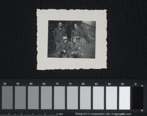 Four sailors in a garden