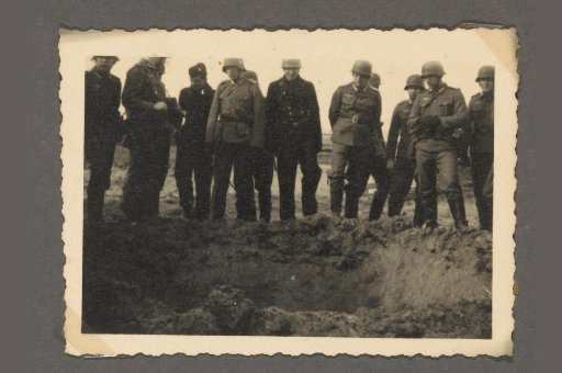 Soldiers by a pit after a mine explosion