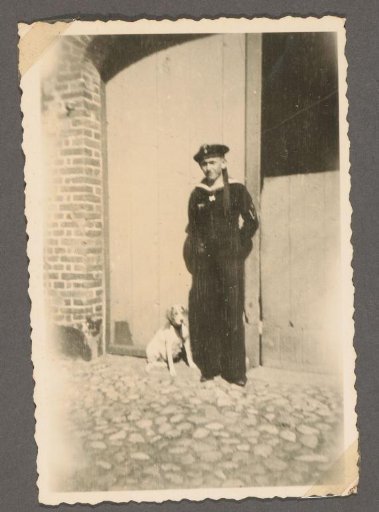 Portrait of a Soldier in Uniform with a Dog in Front of a Door